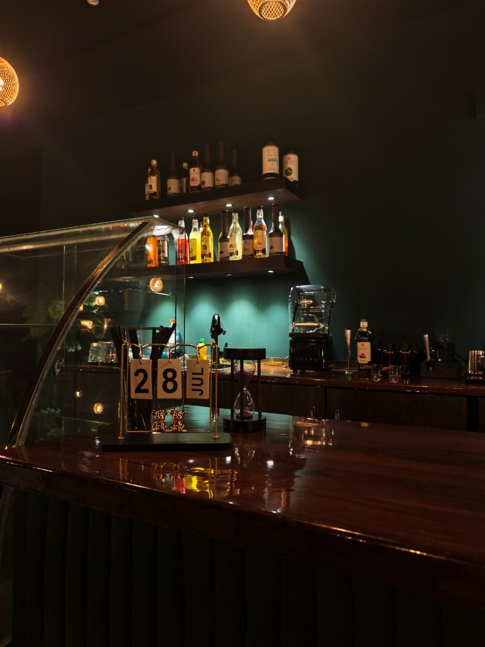 The polished Caffio counter with warm reflections and the preparation bar behind it